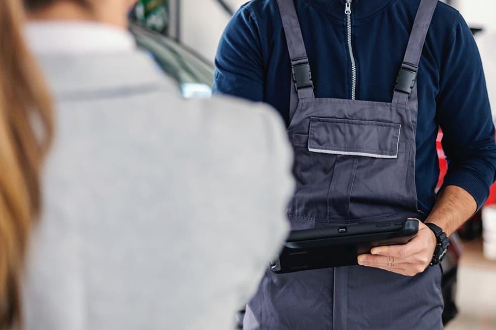 Mechaniker Mit Tablet In Arbeitskleidung Berät Kunde